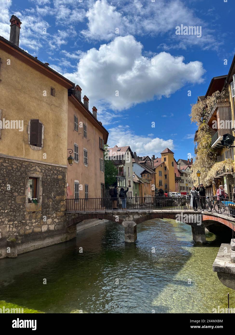 Annecy, Haute-Savoie, France: skyline of the old town and the crystal clear waters of one of the canals of the Thiou River, French Venice Stock Photo