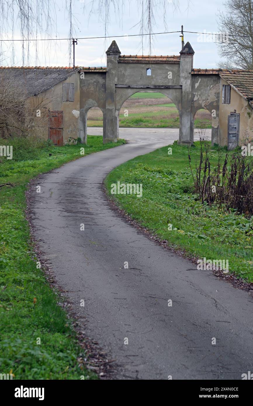Entrance to a rustic farm with old walls in the Pokupje region, Croatia ...