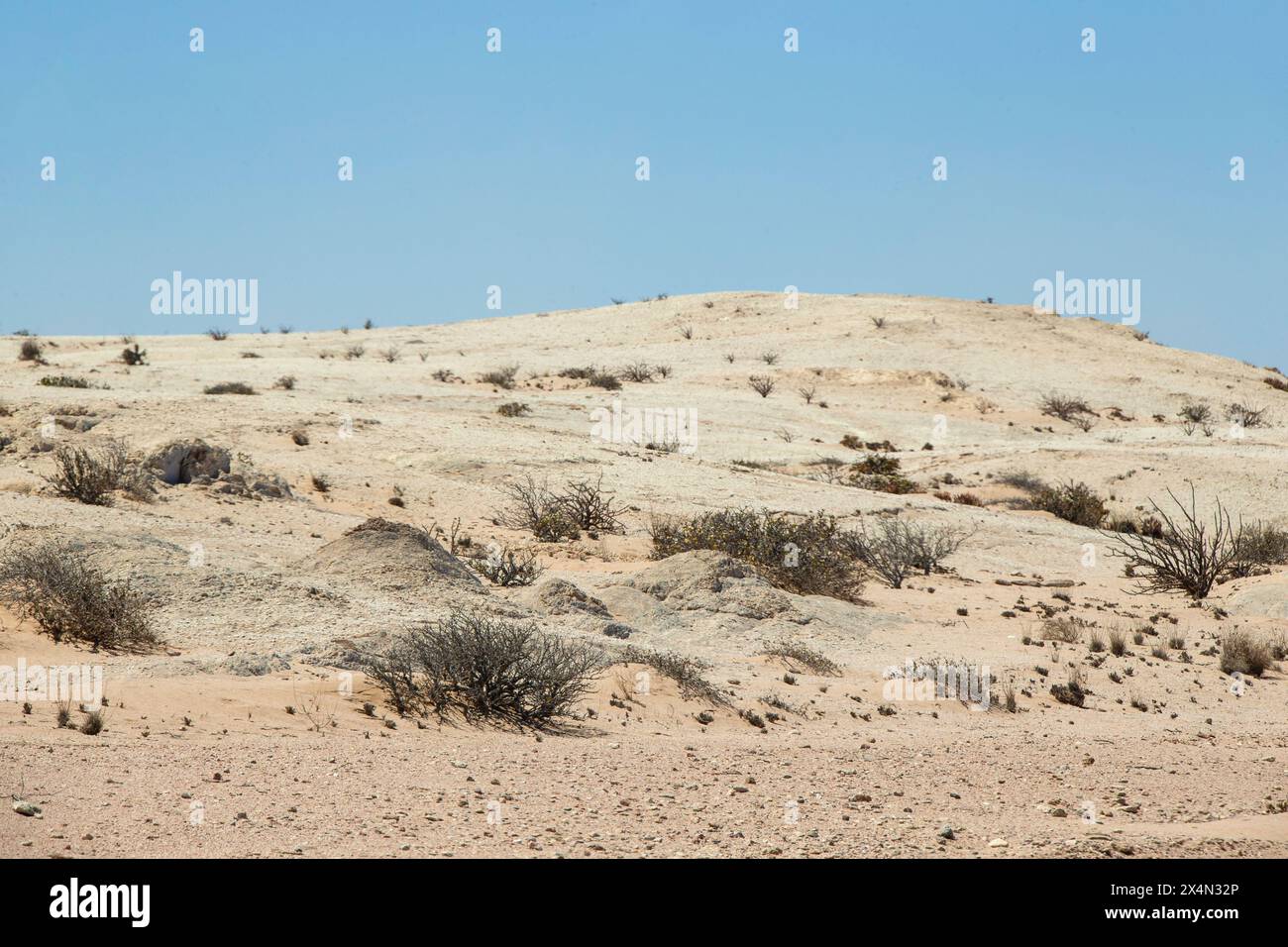 A smooth; granite mound out in the Namib Desert. Stock Photo