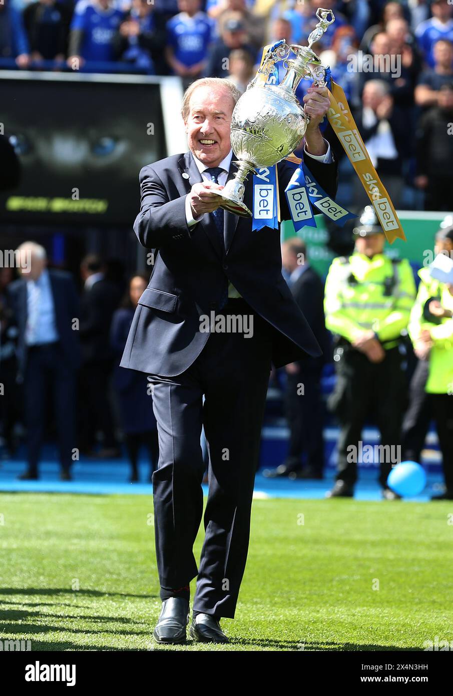 Leicester City ambassador Alan Birchenall carries out the league trophy after the Sky Bet Championship match at the King Power Stadium, Leicester. Picture date: Saturday May 4, 2024. Stock Photo