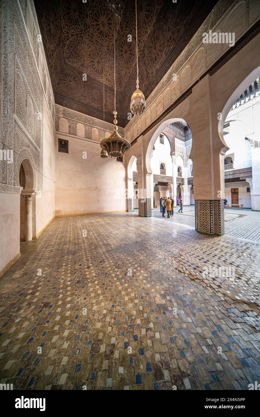 Visitors exploring the historic Cherratine Madrasa in Fezs bustling