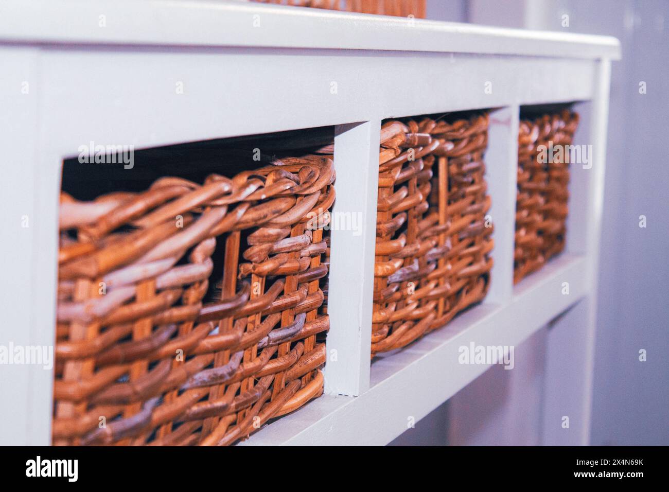 Wicker baskets on a shelf in a store, close-up Stock Photo