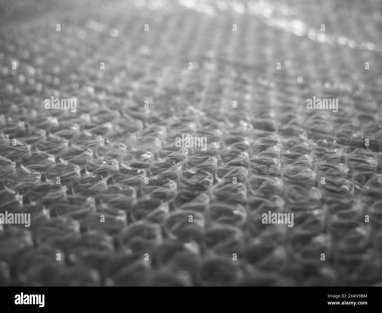 Packaging Material. Detailed view of bubble wrap on green surface. Stock Photo