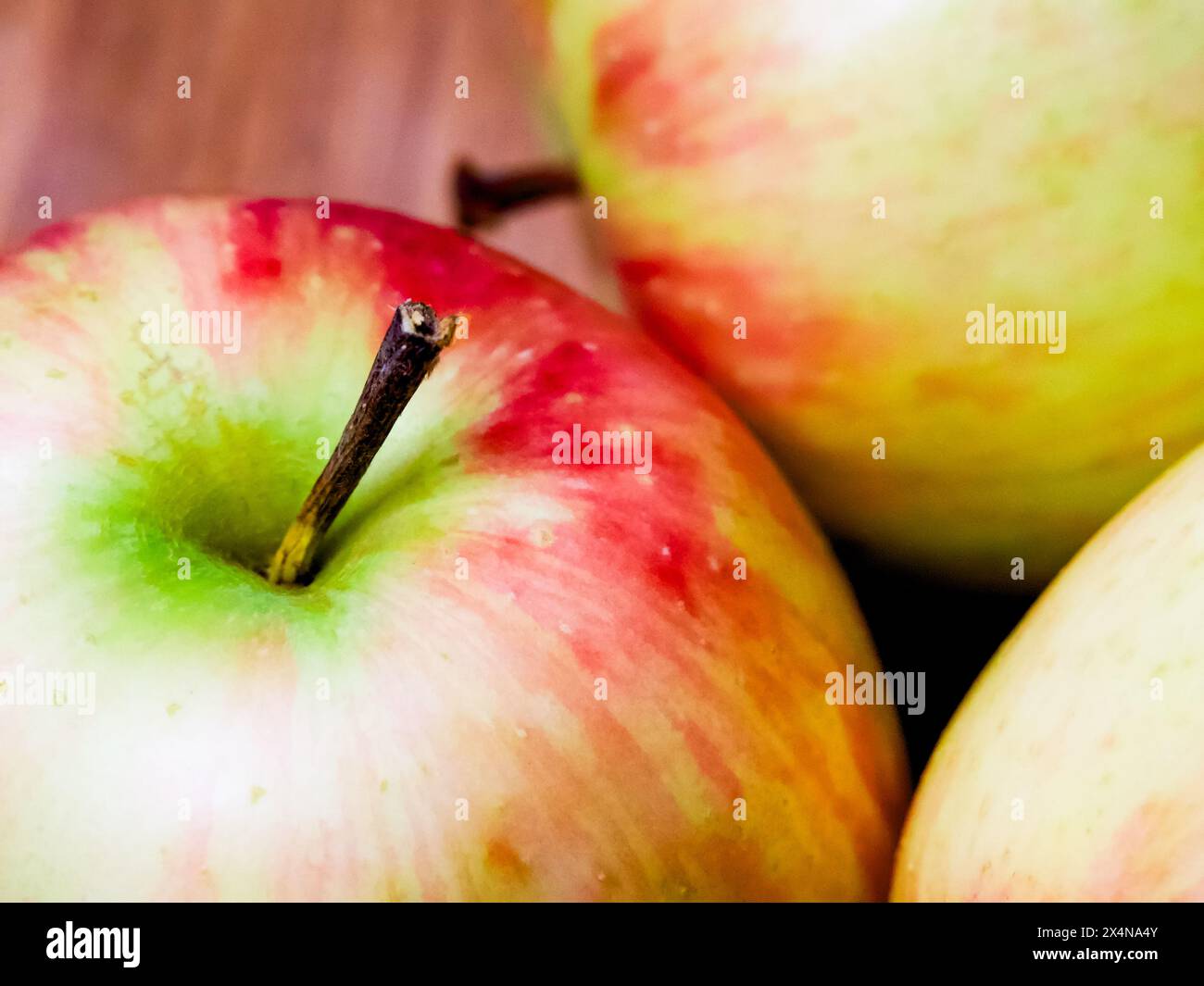 Colorful Apple Composition. Apples with varying shades, set against wood, suitable for dietary content. Stock Photo