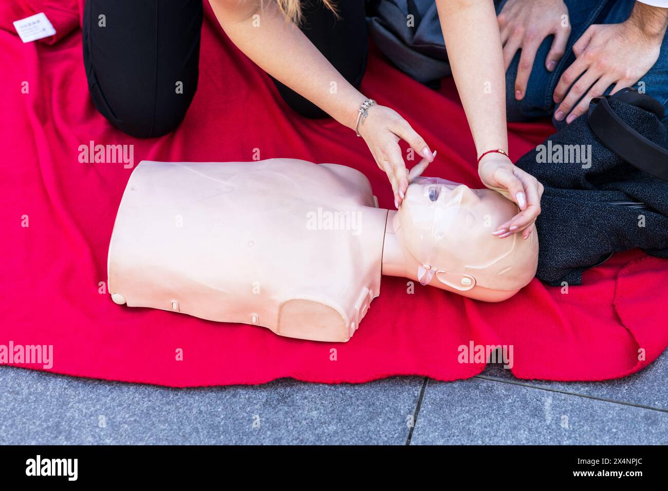 Taking a pulse or heart rate during first aid Stock Photo - Alamy