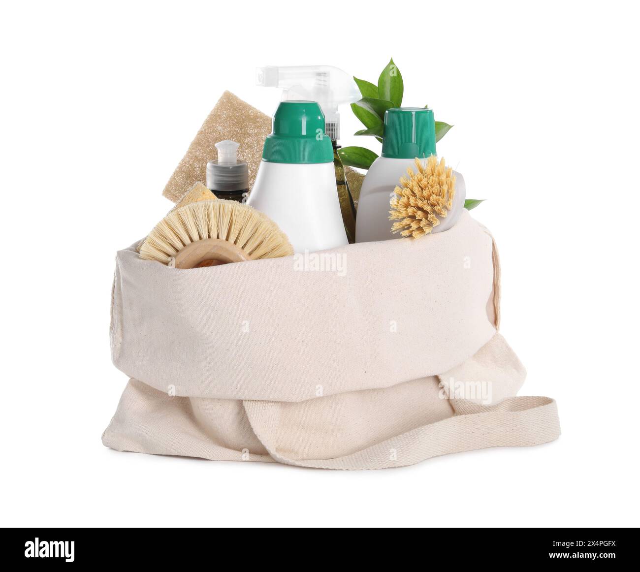 Bottles of cleaning product, brushes, sponges and green leaves in eco bag isolated on white Stock Photo
