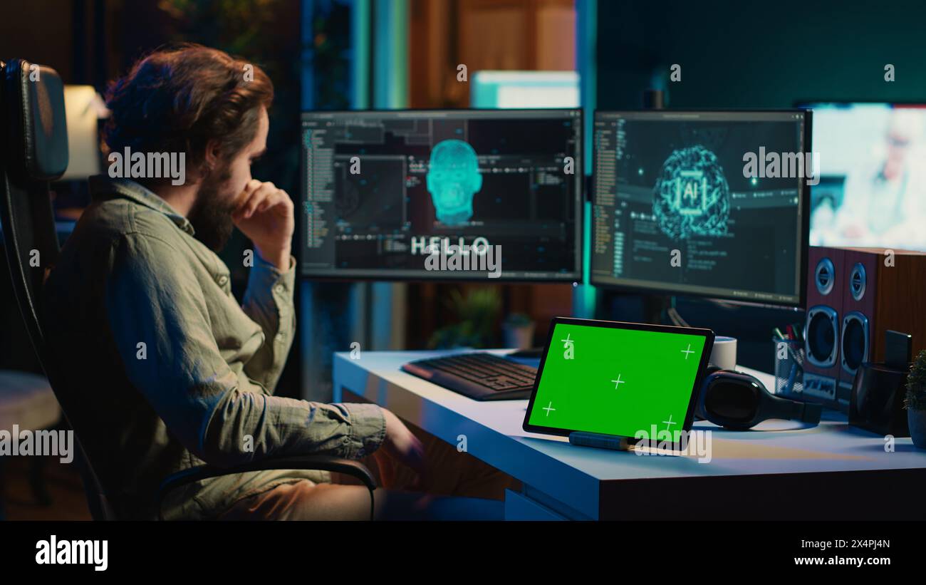 Developer using green screen tablet updating artificial intelligence ...