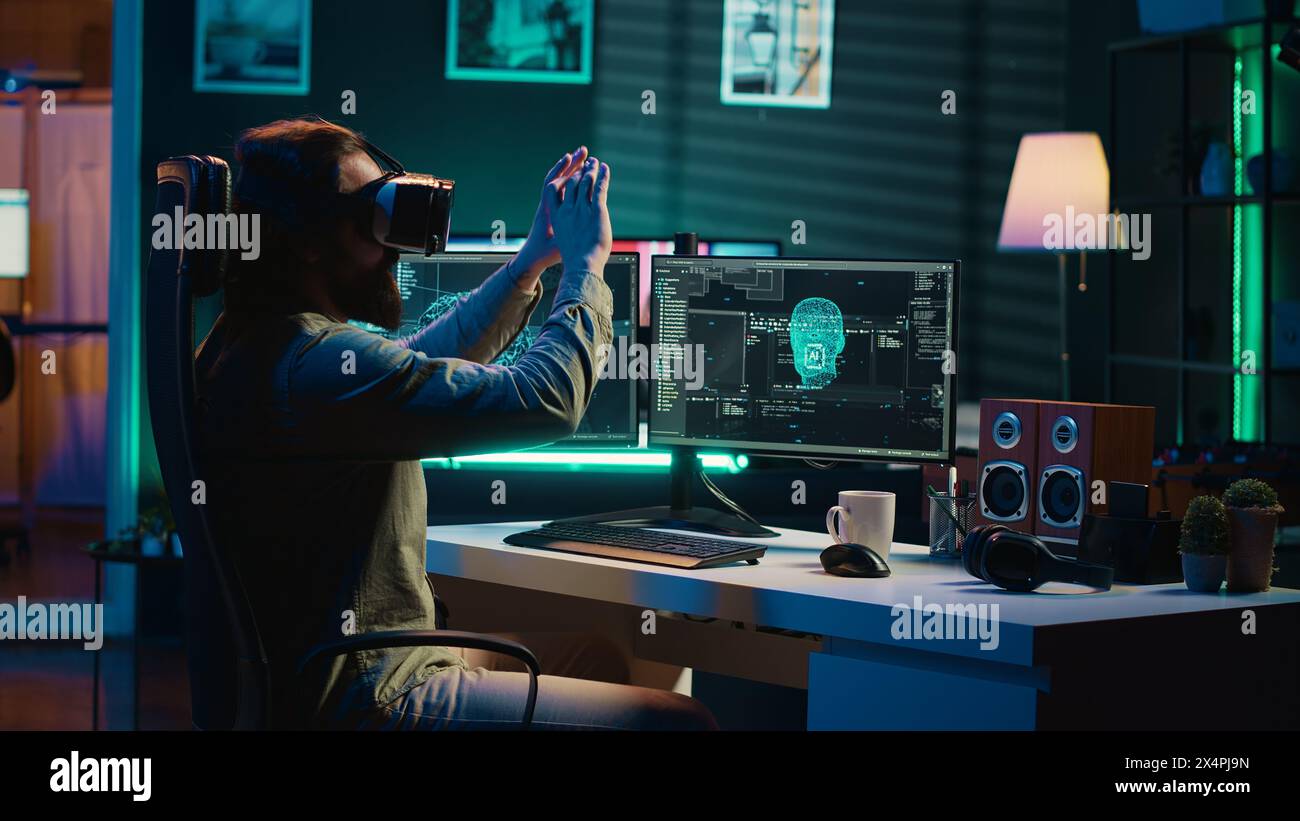 Ecstatic man celebrating after awakening AI using VR headset, making it ask existential questions. Happy developer excited to chat with artificial intelligence using virtual reality tech, camera A Stock Photo