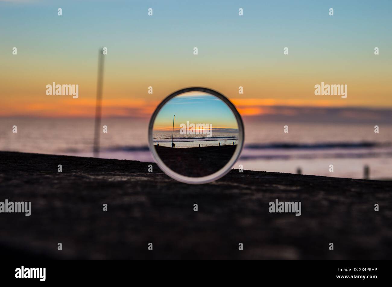 Sunset on the beach trough a lens Stock Photo