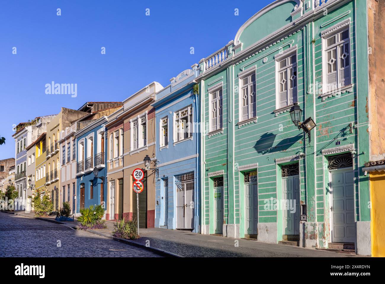 Easter Cross Monument, Monumento da Cruz do Pascoal, and colorful colonial architecture in the Pelourinho district, Salvador, Bahia, Brazil Stock Photo