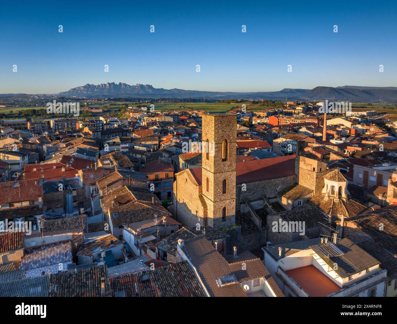 Aerial view of the Sant Pere bell tower and the village of Santpedor on a spring sunrise (Bages, Barcelona, Catalonia, Spain) Stock Photo