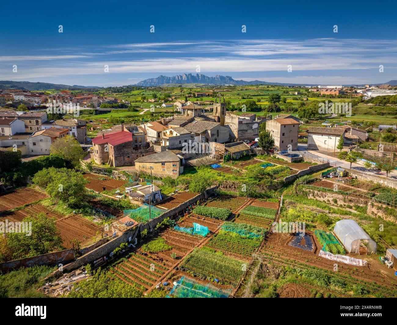 Aerial view of the historic center and the church of Sant Fruitós de Bages on a spring morning. In the background, the Montserrat mountain (Spain) Stock Photo
