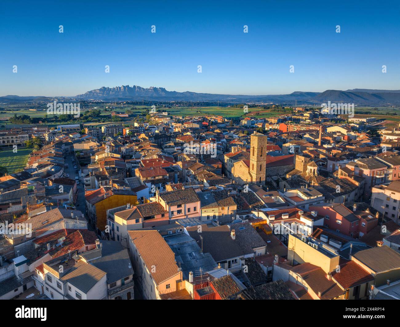 Aerial view of the Sant Pere bell tower and the village of Santpedor on a spring sunrise (Bages, Barcelona, Catalonia, Spain) Stock Photo