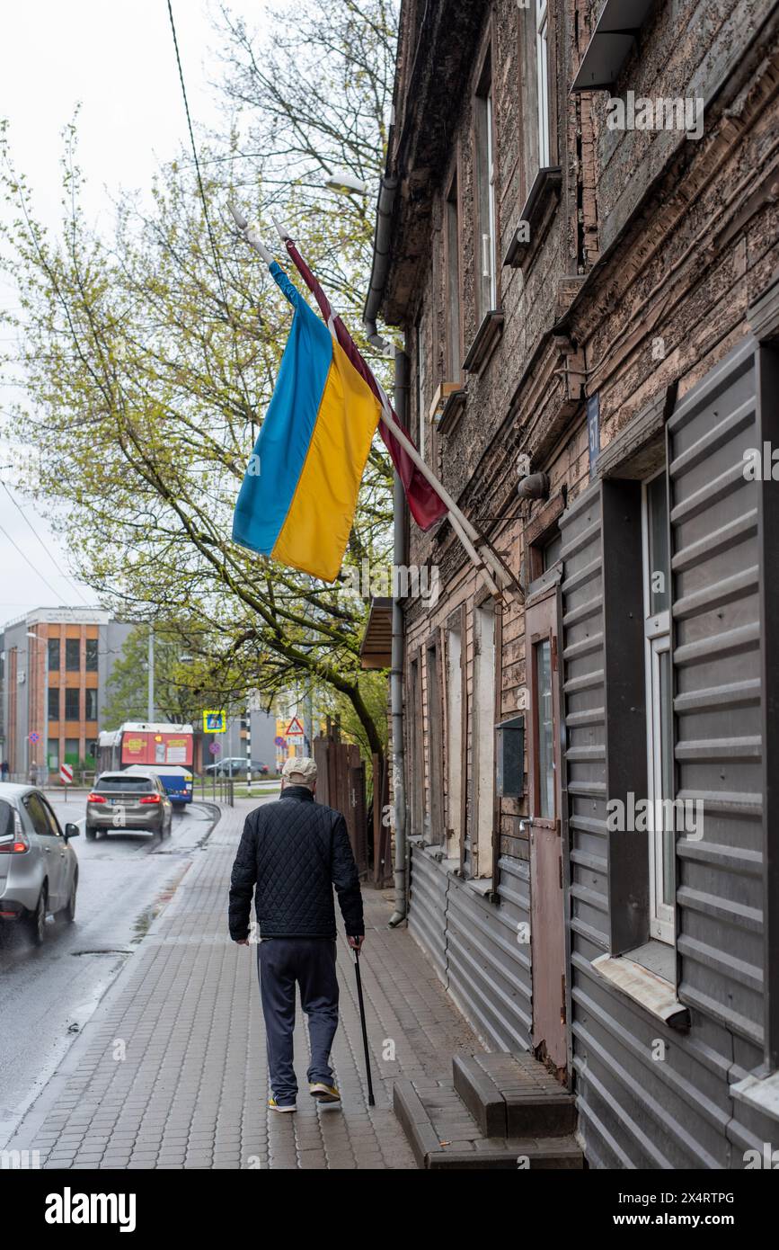 The Latvian and Ukrainian flags hang from a wooden house in Riga, Riga, Latvia Stock Photo