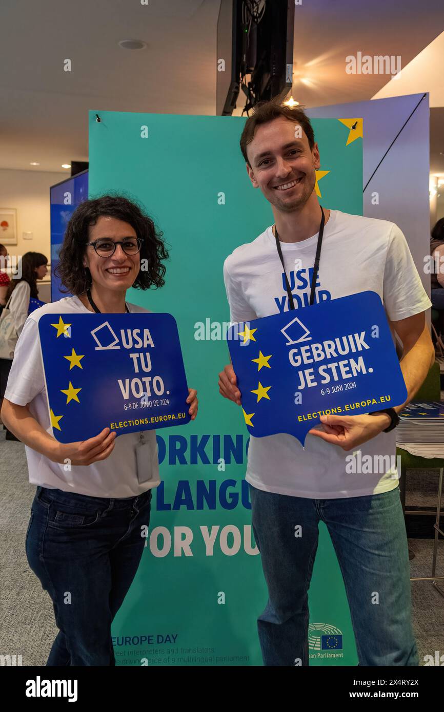 EU Parliament workers encourage people to vote in the up coming elections during an open day to celebrate the birthday of the European Parliament in Brussels. Celebrating the European Parliament's birthday in Brussels, visitors gained special access to the Parliament chambers and the iconic building itself. The open day featured informative stands on the upcoming European Parliament elections, fostering political engagement and dialogue. Against the backdrop of European democracy, attendees immersed themselves in the legislative process, symbolizing transparency and civic participation. The ev Stock Photo