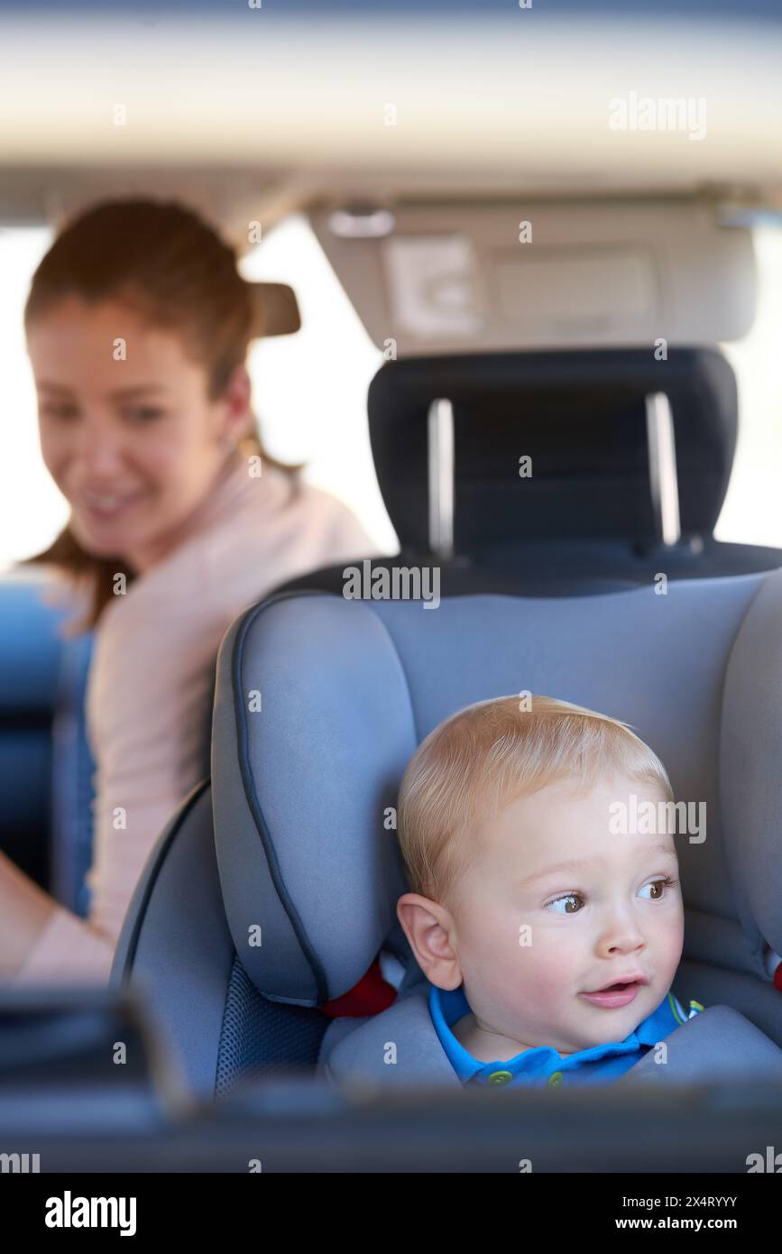 Travel, mom and baby on drive, car and love for child, seat belt and secure in vehicle and morning. Check, toddler and mother on road trip, transport Stock Photo