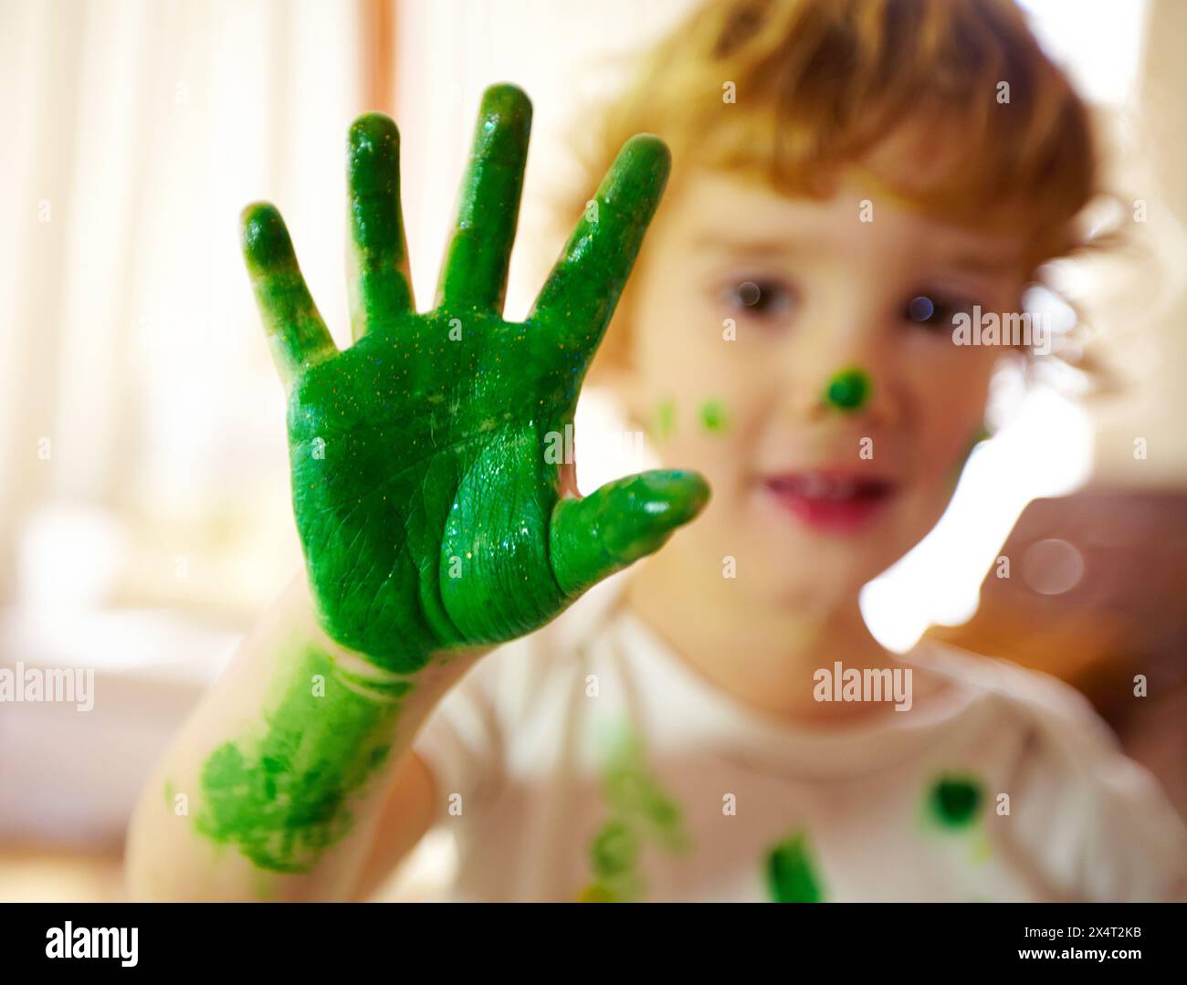 Preschool, hand and paint for boy, color and creativity, growth and development of child with mess. Childcare, learning and craft for artwork, closeup Stock Photo