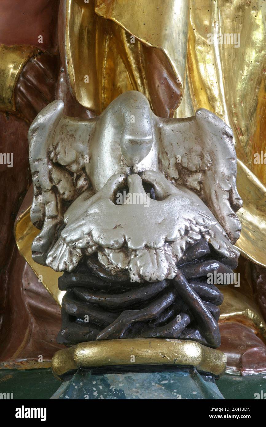 A pelican feeds its young, a Christian symbol, statue on the main altar ...