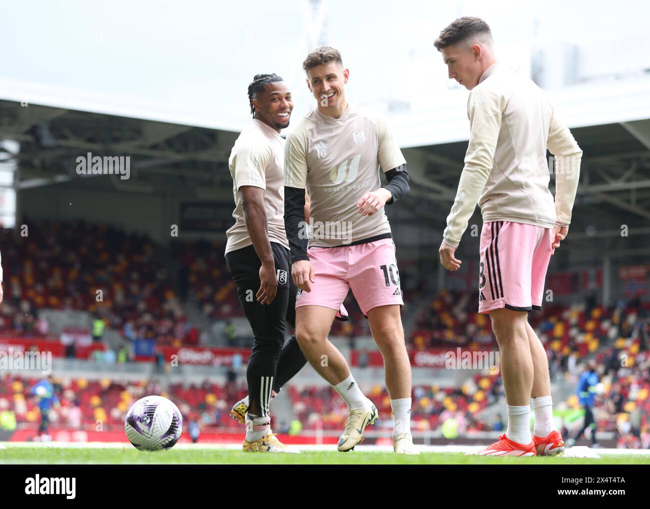London, UK. 4th May, 2024. Adama Traoré (L) and Tom Cairney (C) of Fulham share a joke during the warm up before the Premier League match at Gtech Community Stadium, London. Picture credit should read: Paul Terry/Sportimage Credit: Sportimage Ltd/Alamy Live News Stock Photo