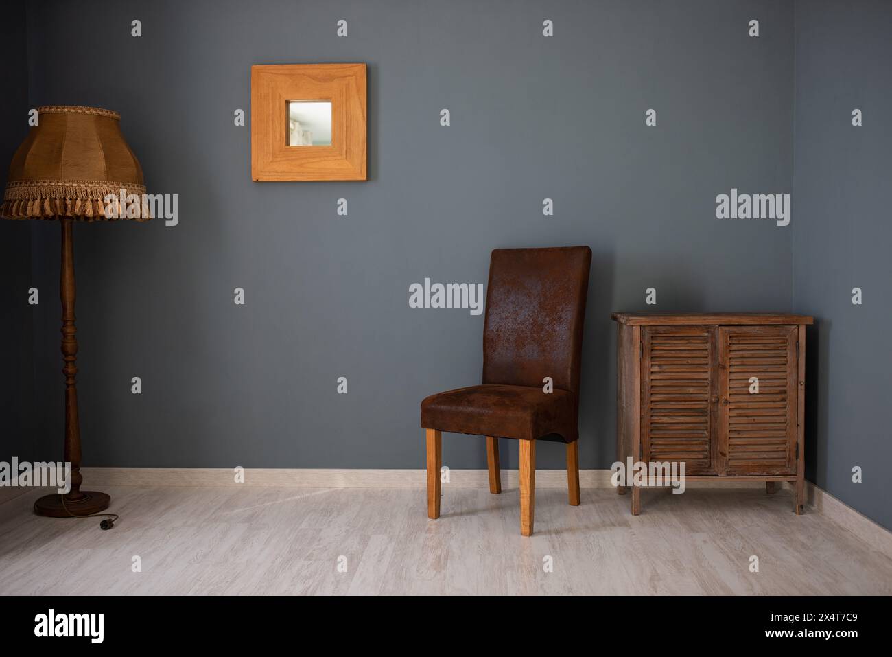 Aesthetic composition of living room interior with mock up posters frame, stylish wooden sideboard, books, gray wall with stucco and personal accessor Stock Photo