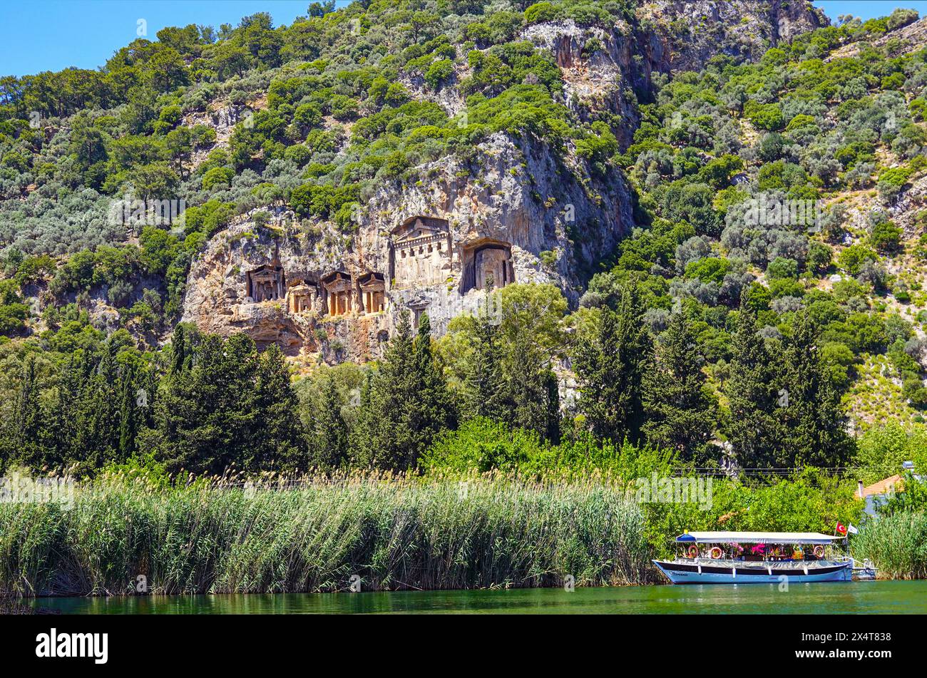 tourist-river-boats-and-royal-lycian-tombs-carved-into-rock-face-at