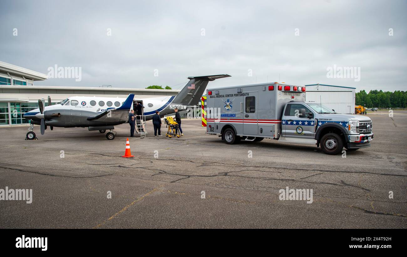 A Navy active-duty patient arrives at the Hampton Roads Executive Airport through Project Caladrius prior to being transported via ambulance to Naval Stock Photo
