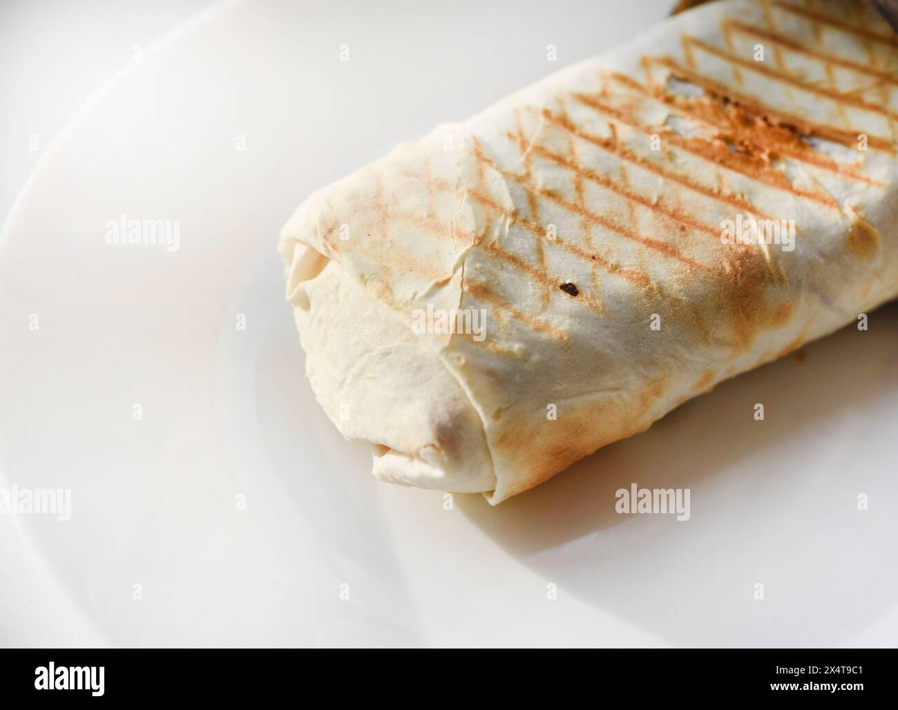 Meat shawarma on a white plate. A meat delicacy. Gyros kebab Stock ... Meat shawarma on a white plate. A meat delicacy. Gyros kebab Stock ...