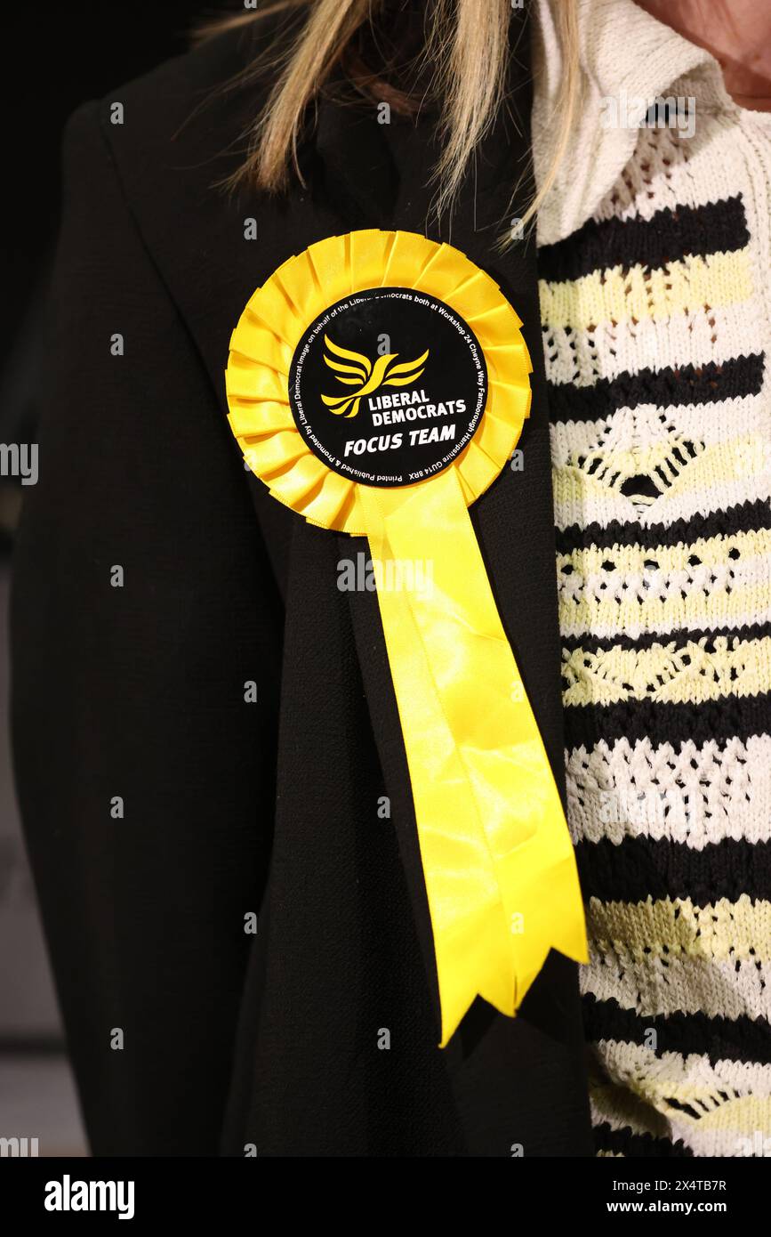 Peterborough, UK. 03rd May, 2024. A yellow Lib Dem (Liberal Democrats) rosette. Voting forms are in, and counting has begun at KingsGate Community Church in Peterborough, after voters went to the polling booths for the local council elections and election of the Police and Crime Commissioner for Cambridgeshire police area. Voters had to take photographic identification to the polling stations in Peterborough, Cambridgeshire, or they would not be able to vote. Local elections, Peterborough, Cambridgeshire, on 2nd May, 2024. Credit: Paul Marriott/Alamy Live News Stock Photo