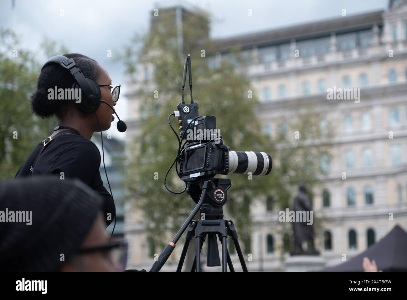 Woman films an event at Trafalgar Square, London, May 4th 2024 Stock