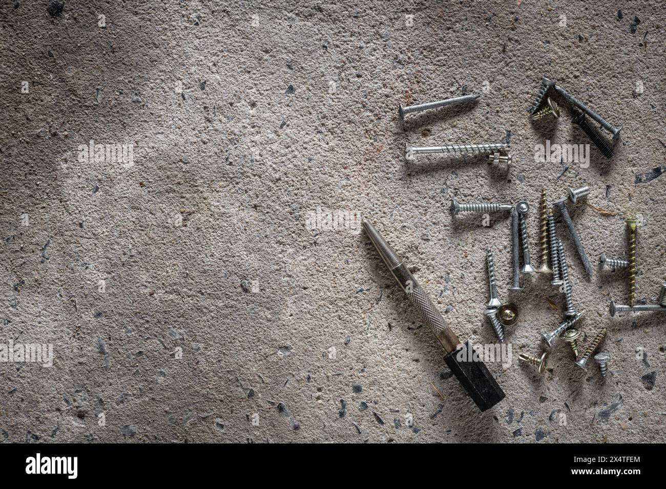 Screw, nail on concrete texture background. Closeup of screws and nails