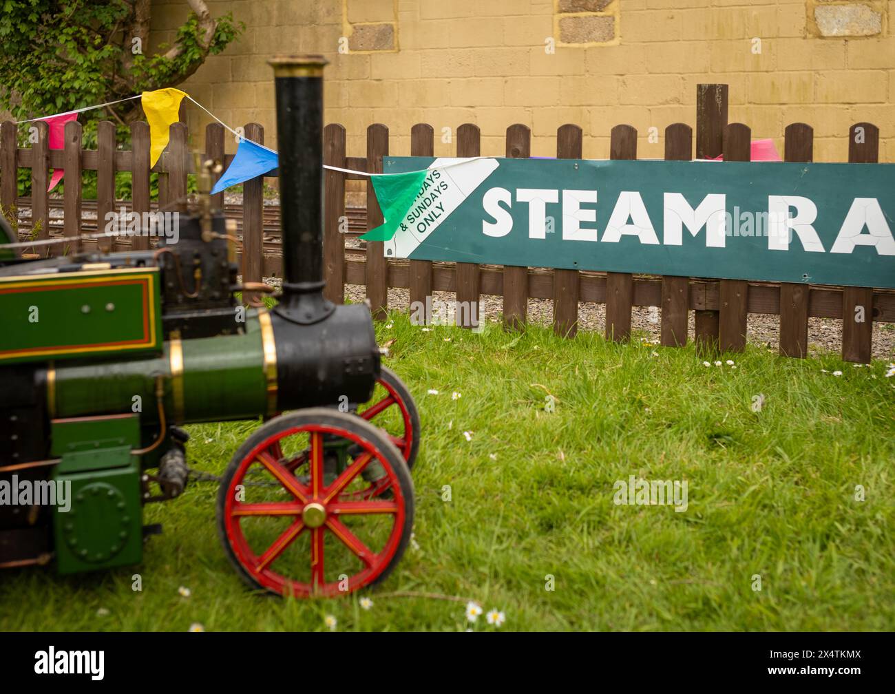 A minature steam powered traction engione next to the word 'Steam' at South Downs Light Railway, Pulborough, UK Stock Photo