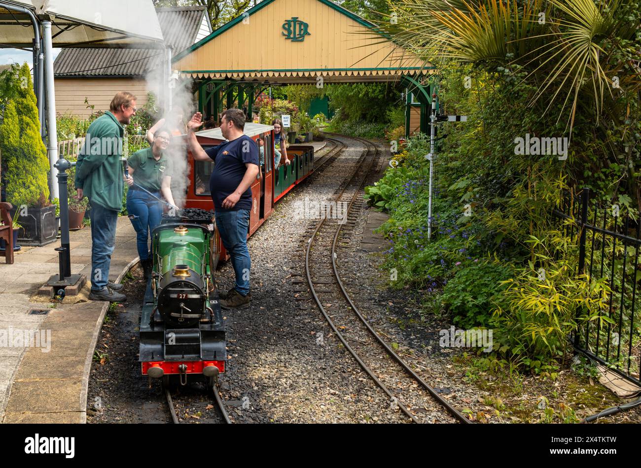Volunteers ready The Railway Mission minature steam locomotive and its carriages at South Downs Light Railway, Pulborough, UK Stock Photo