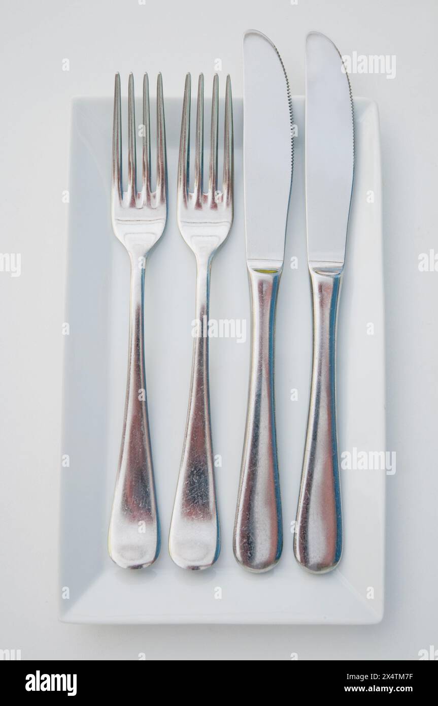 Two forks and two knifes Stock Photo