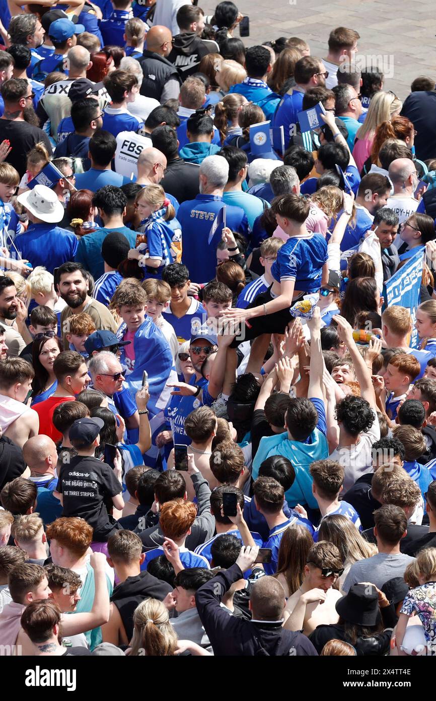 A Leicester City is thrown into the air by fans gathered ahead of the open-top bus parade in Leicester to celebrate winning the Sky Bet Championship title. Picture date: Sunday May 5, 2024. Stock Photo