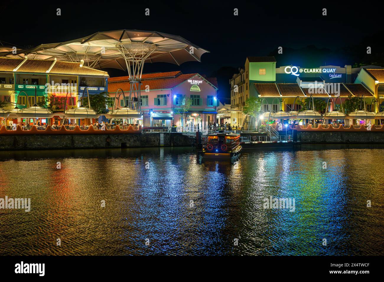 Clarke Quay, from the Singapore River at night Stock Photo