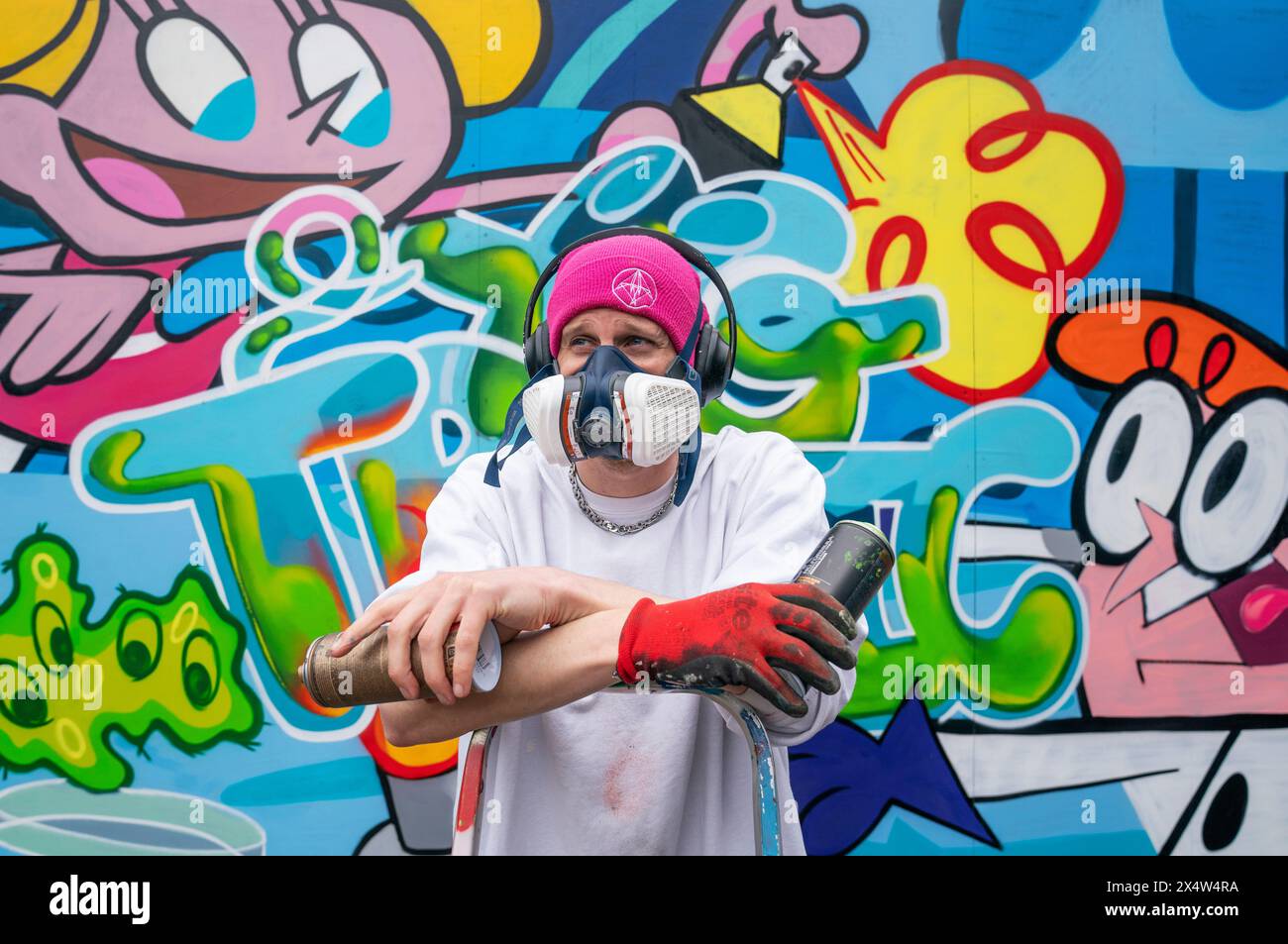 Artist Tragic O'Hara alongside part of his mural at the Yardworks Festival 2024 in Glasgow. The festival is one of Europe's biggest events dedicated to street art and graffiti. Picture date: Sunday May 5, 2024. Stock Photo