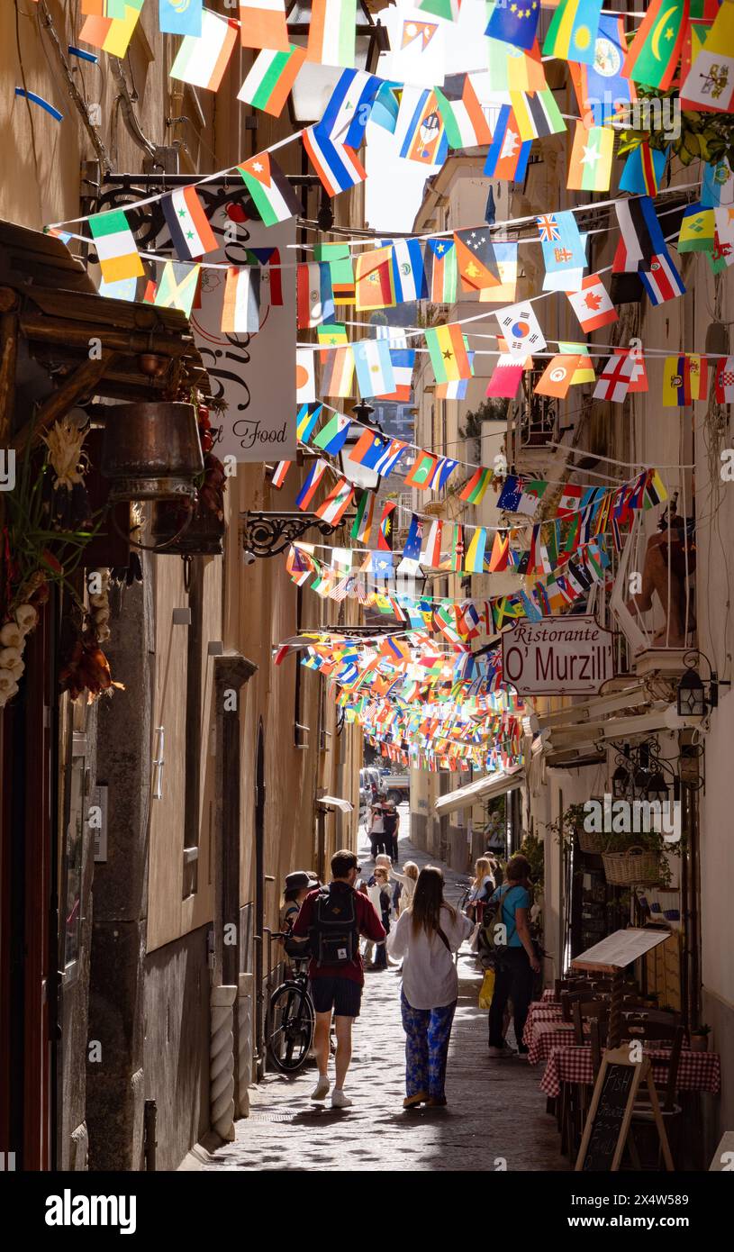 Colorful Sorrento street scene with narrow street, flags and bunting on a sunny summer day, Sorrento Italy Europe Stock Photo