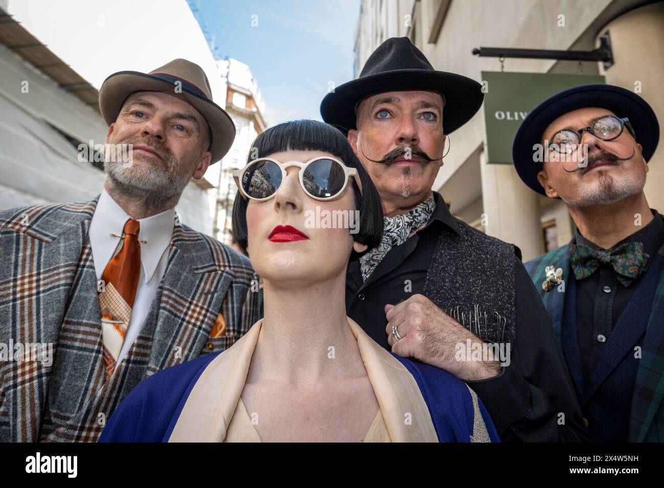 London, UK.  5 May 2024.  Elegantly dressed people take part in the fourth Grand Flâneur walk. Starting at the Beau Brummell statue on Jermyn Street, the walk coincides with the 25th anniversary of The Chap magazine and is defined as a walk without purpose, celebrating the art of the flâneur, oblivious to going anywhere specific, and an antidote to the demands of modern life and the digital smartphone.  Credit: Stephen Chung / Alamy Live News Stock Photo