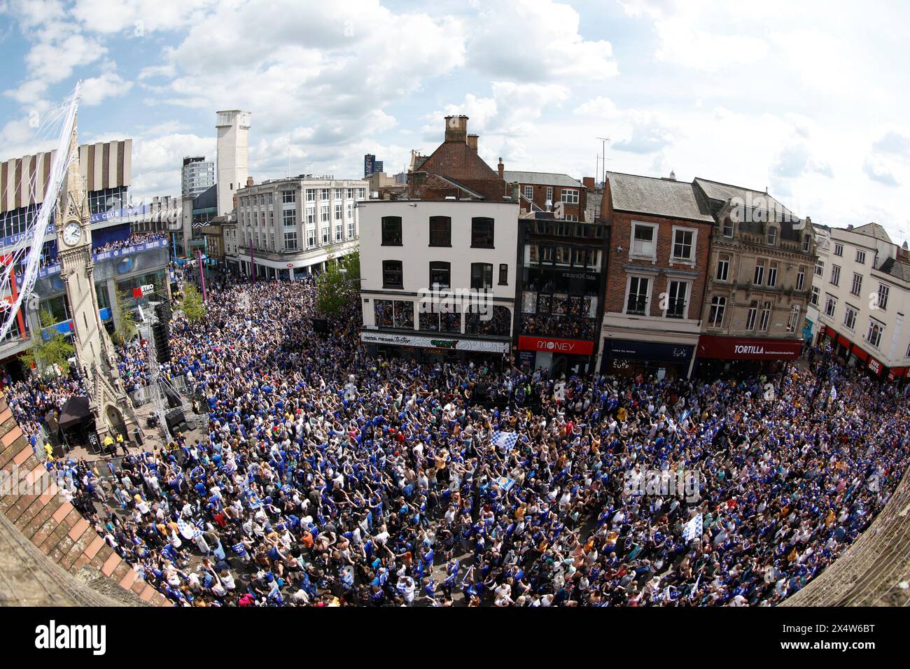 Leicester City fans cheer the players and management on the balcony (top left) during a parade in Leicester to celebrate winning the Sky Bet Championship title. Picture date: Sunday May 5, 2024. Stock Photo
