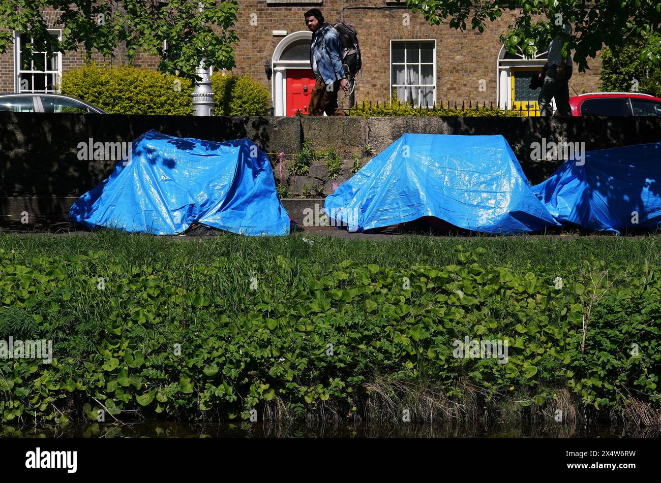 A view of tents which have been pitched by asylum seekers along a stretch of the Grand Canal, Dublin, near to the International Protection Office (IPO) on Mount Street where a makeshift migrant camp was dismantled earlier this week and 'just under' 290 people were removed during the multi-agency operation. Picture date: Sunday May 5, 2024. Stock Photo