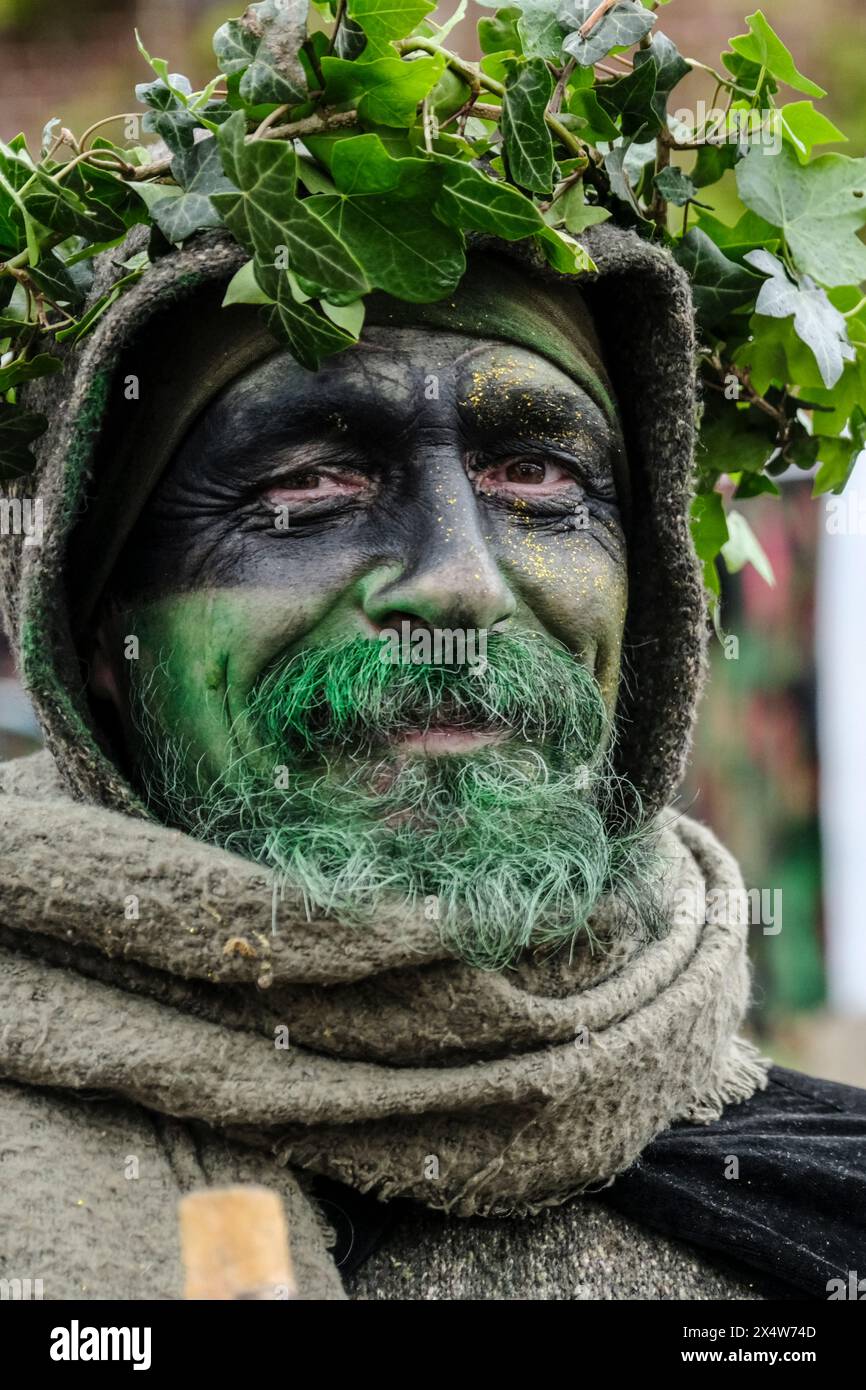 Glastonbury, UK. 5th May, 2024. The Green Man waits for the dragons. May Fayre and the Dragon procession is part of a week of celebrations to mark Beltane and May Day. The festival has its roots in early Gaelic seasonal celebrations, it fits in well with the new age community that this small Somerset town attracts. Credit: JMF News/Alamy Live News Stock Photo