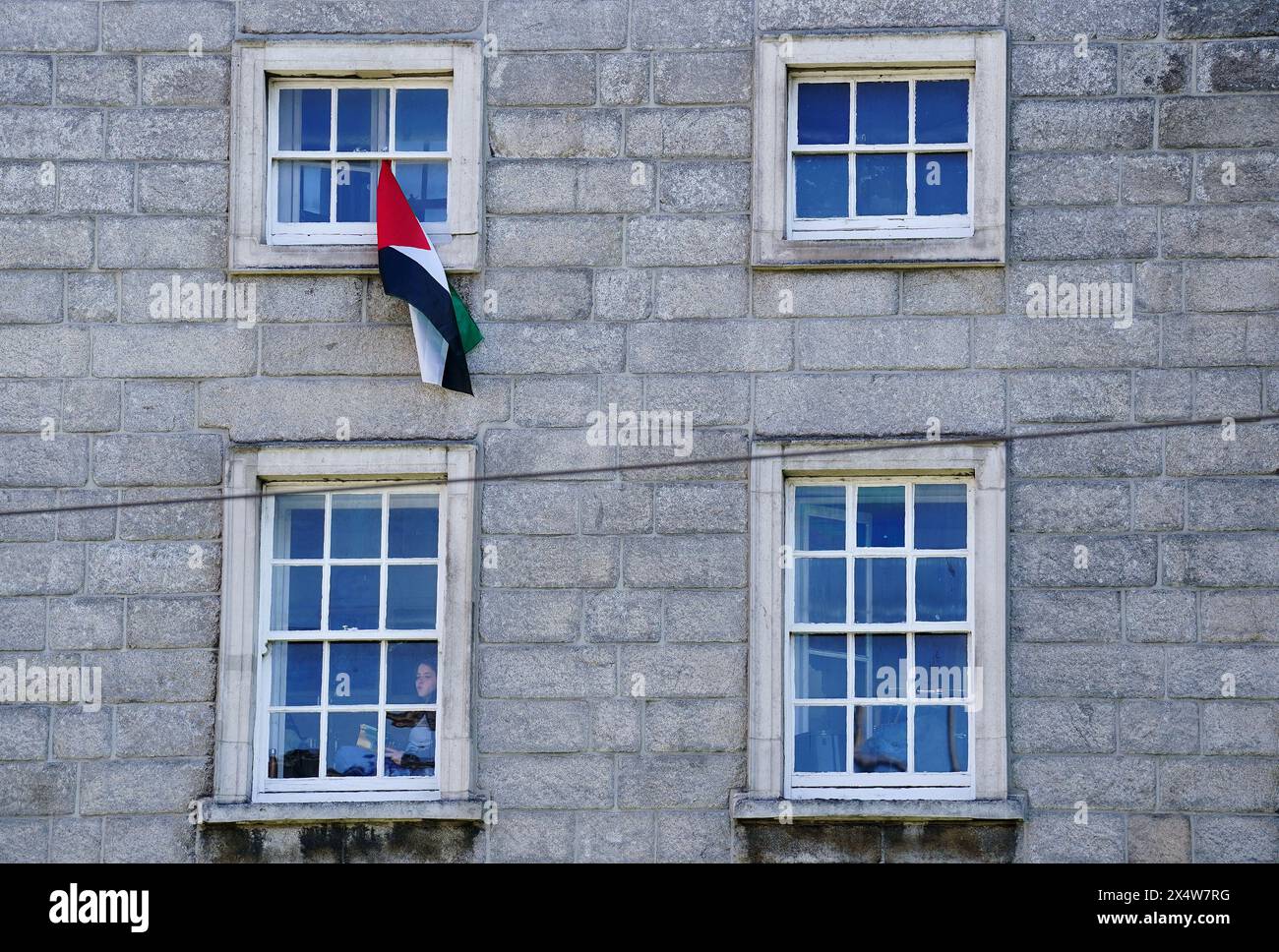 Palestine flags hang from windows of Trinity College in Dublin. The campus remains closed to the public due to an ongoing pro-Palestinian encampment on its grounds. Picture date: Sunday May 5, 2024. Stock Photo