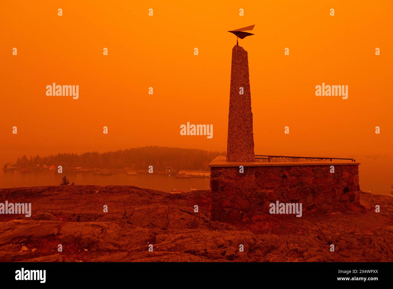 Orange sky at Pilot's Monument in Yellowknife, 2 weeks after reopening of city following a 3-week long wildfire evacuation, Northwest Territories. Stock Photo