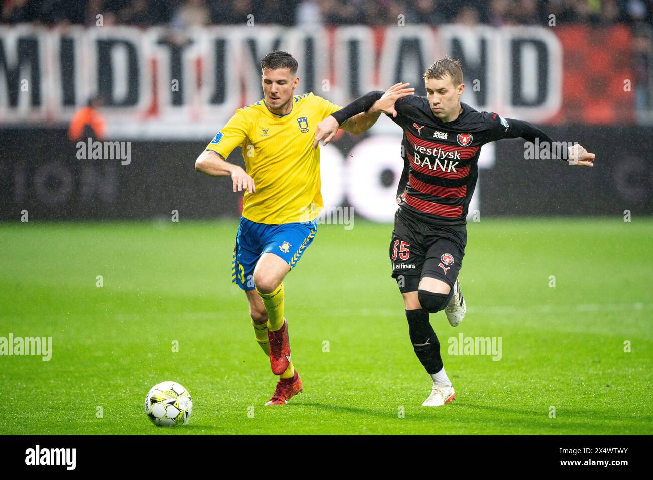 Herning, Denmark. 05th May, 2024. FCM's Rigon Matos Charles in battle with Broendby's Jordi Vanlerberghe during the Superliga match between FC Midtjylland and Broendby IF at MCH Arena in Herning on Sunday, May 5, 2024. (Photo: Bo Amstrup/Ritzau Scanpix) Credit: Ritzau/Alamy Live News Stock Photo