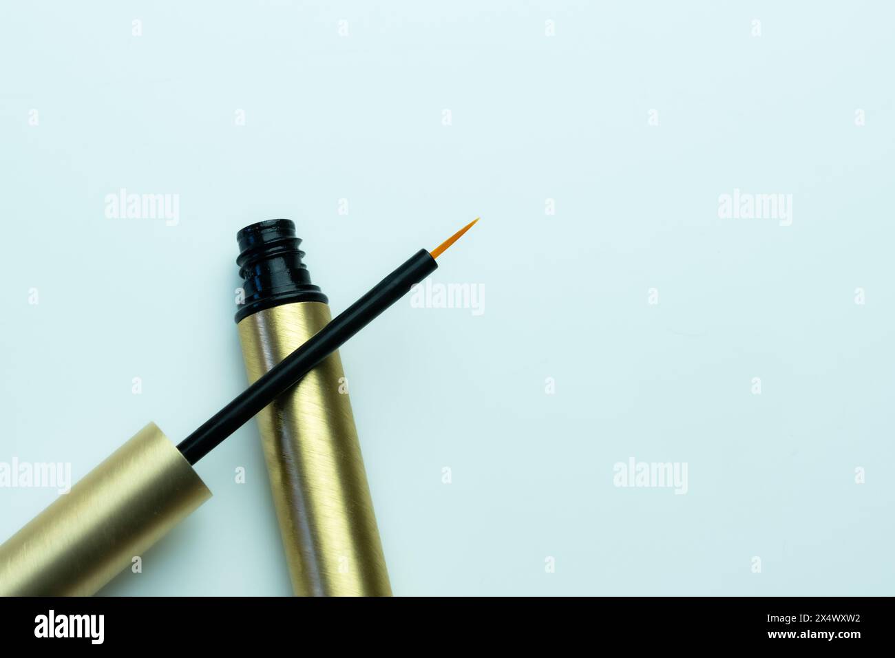 Composition of an open eyeliner on a neutral white background Stock Photo
