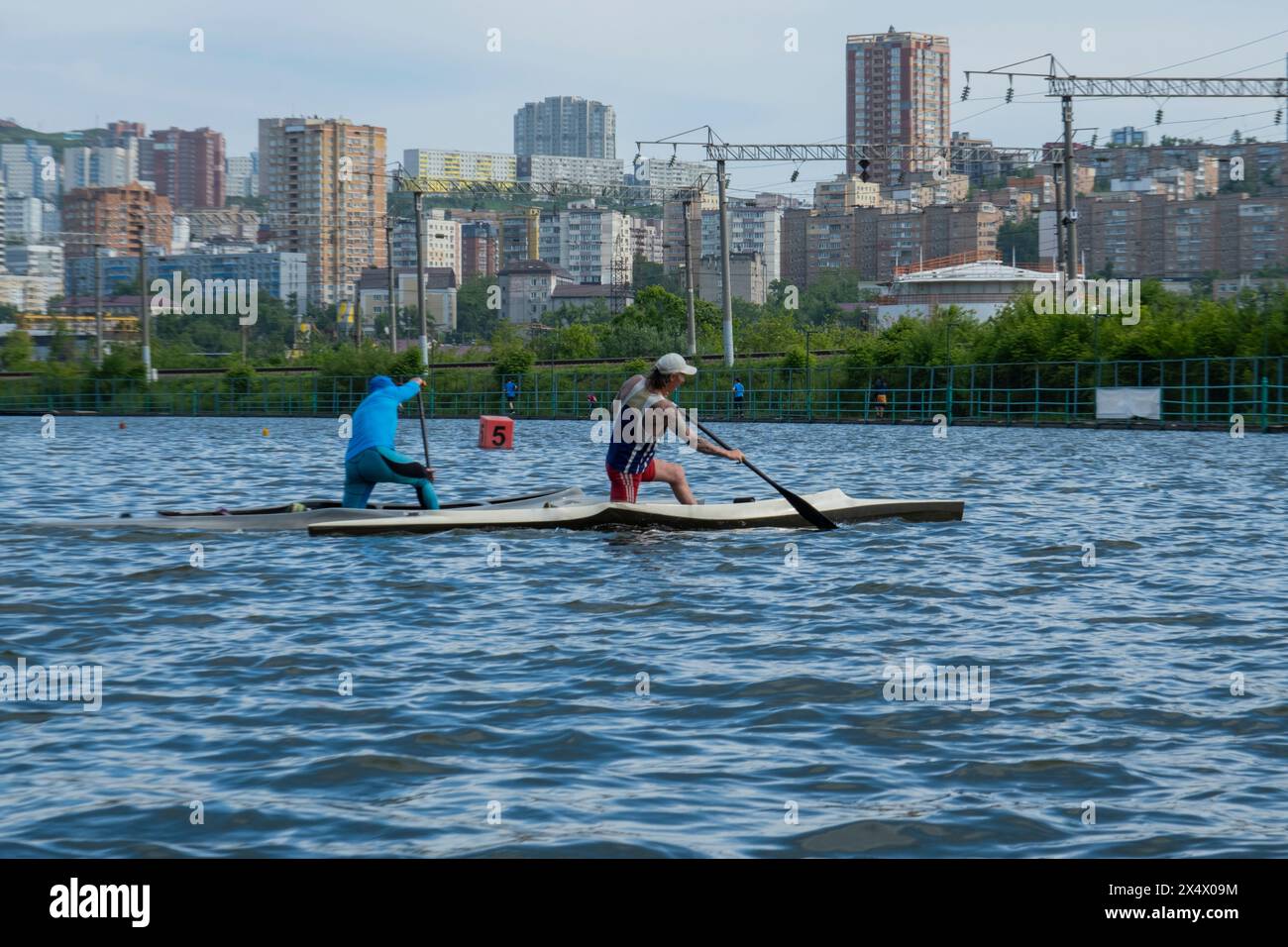Two men paddling a canoe on a lake. Two friends boating Stock Photo - Alamy