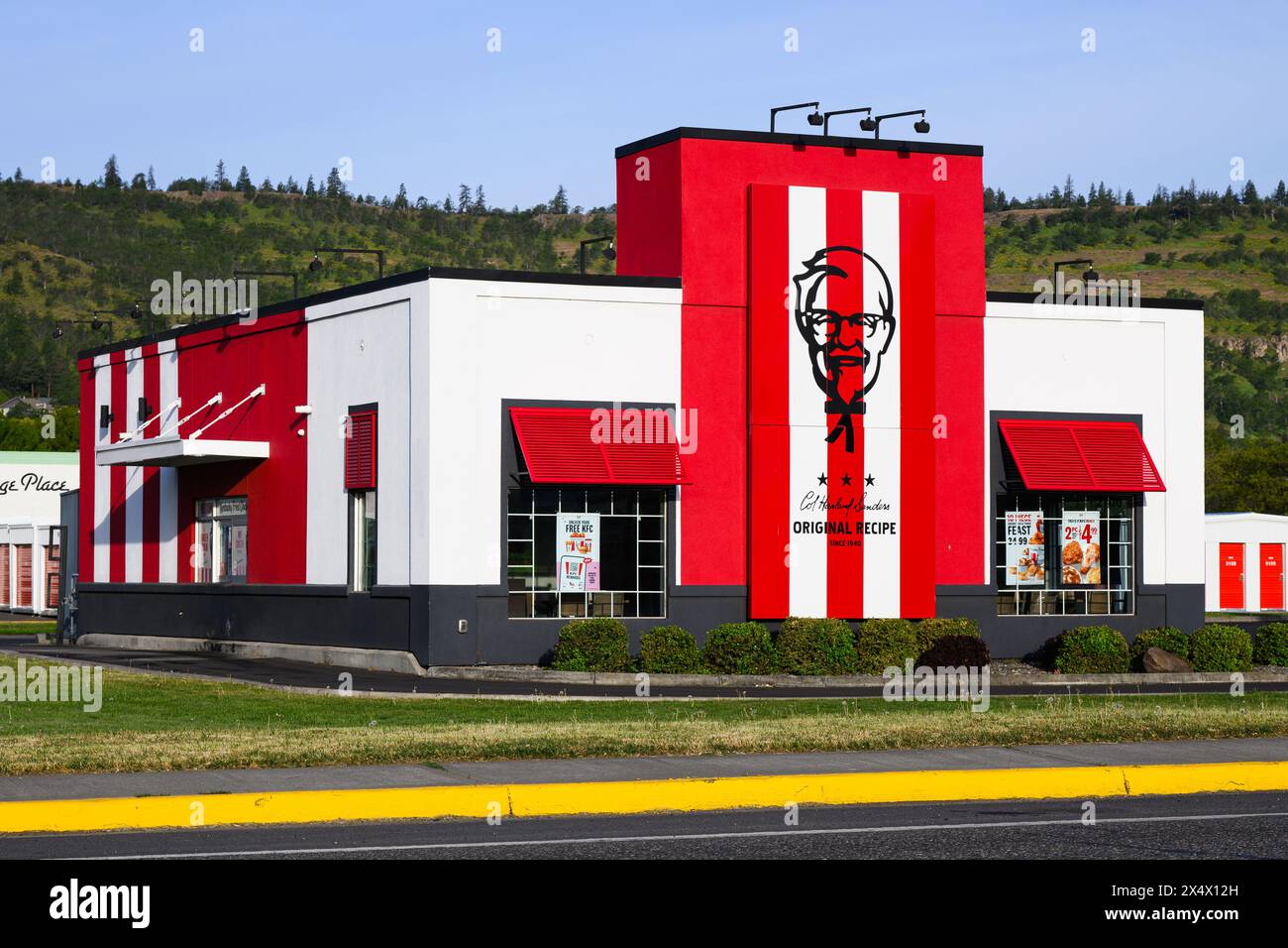 The Dalles, OR, USA - April 23, 2024; Modern KFC fast food Kentucky Fried Chicken restaurant with logo Stock Photo