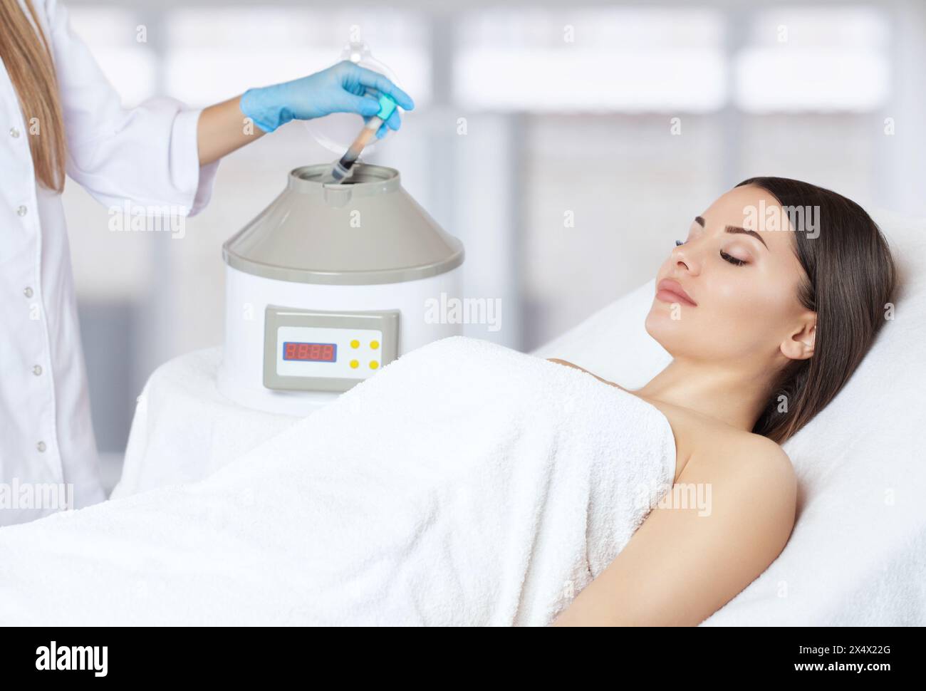 The blood tube is removed from the medical centrifuge for plasma lifting. Prp procedure.Cosmetology and professional skin care. Stock Photo