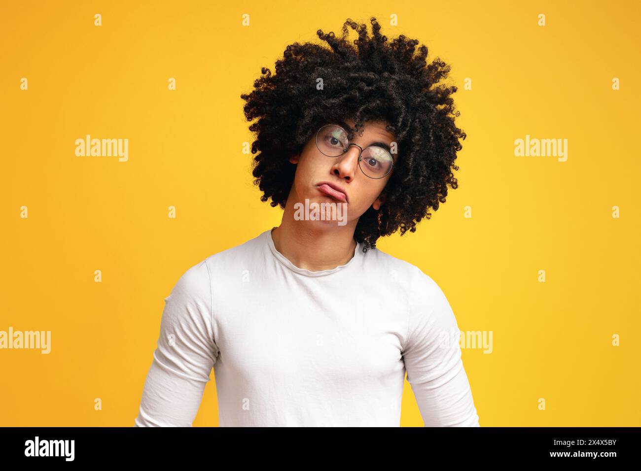 Funny upset african guy pouting lips, looking offended Stock Photo