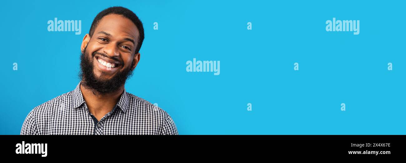 Smiling black man portrait on blue background Stock Photo